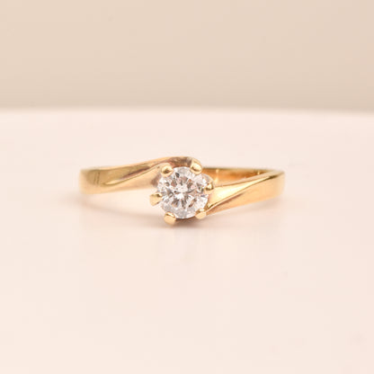 18K yellow gold diamond solitaire engagement ring with a 6-prong spiral setting, size 7.5 US, on a neutral background.