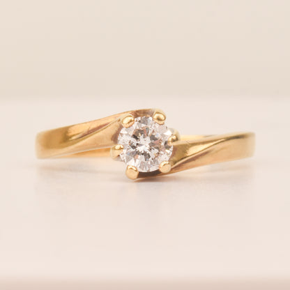 18K yellow gold diamond solitaire engagement ring with a 6-prong spiral setting, size 7.5 US, on a neutral background