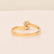 18K yellow gold diamond solitaire engagement ring with a 6-prong spiral setting on a size 7.5 band, displayed on a neutral background.