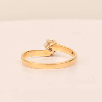 18K yellow gold diamond solitaire engagement ring with a 6-prong spiral setting on a size 7.5 band, displayed on a neutral background.