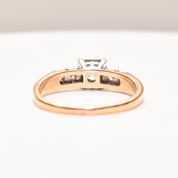 14K two-tone gold engagement ring with 0.25 carat brilliant center diamond and channel set accents, size 9 US, on white background.