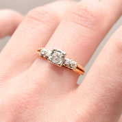 14K two-tone gold diamond engagement ring with .25 carat brilliant center stone, size 9, on a female hand.