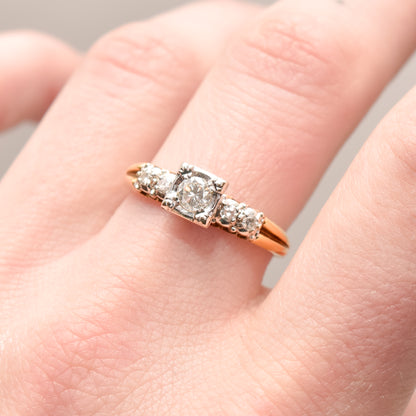 14K two-tone gold diamond engagement ring with .25 carat brilliant center stone, size 9, on a female hand.