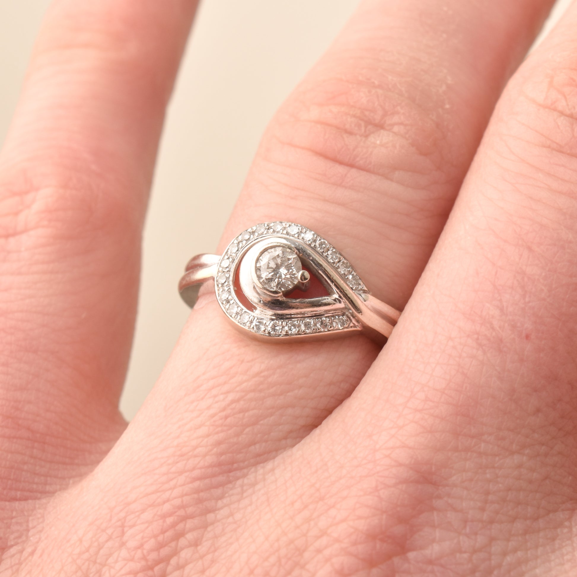 Estate 10K diamond halo engagement ring size 6.75 worn on finger showing intricate details and craftsmanship