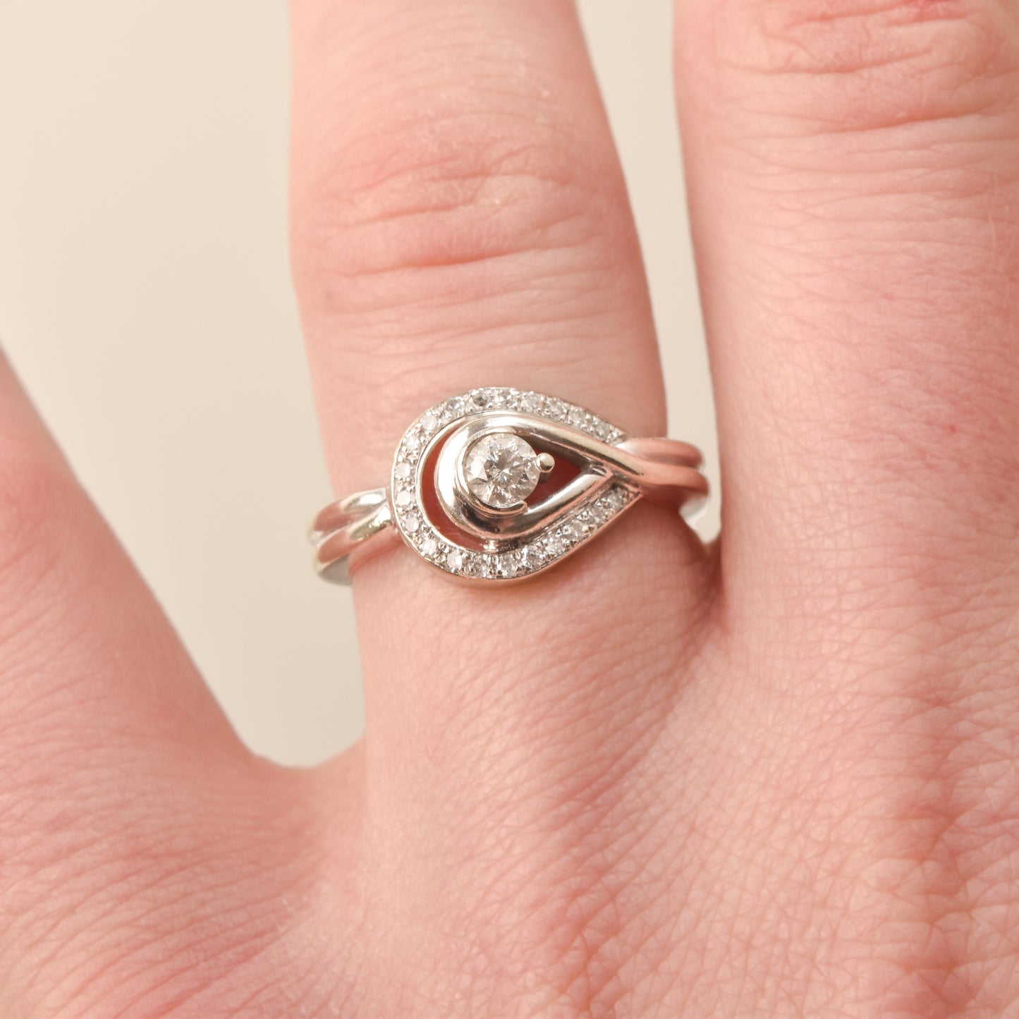 Elegant Estate 10K Diamond Halo Engagement Ring on finger, Size 6 3/4 US, against a neutral background.