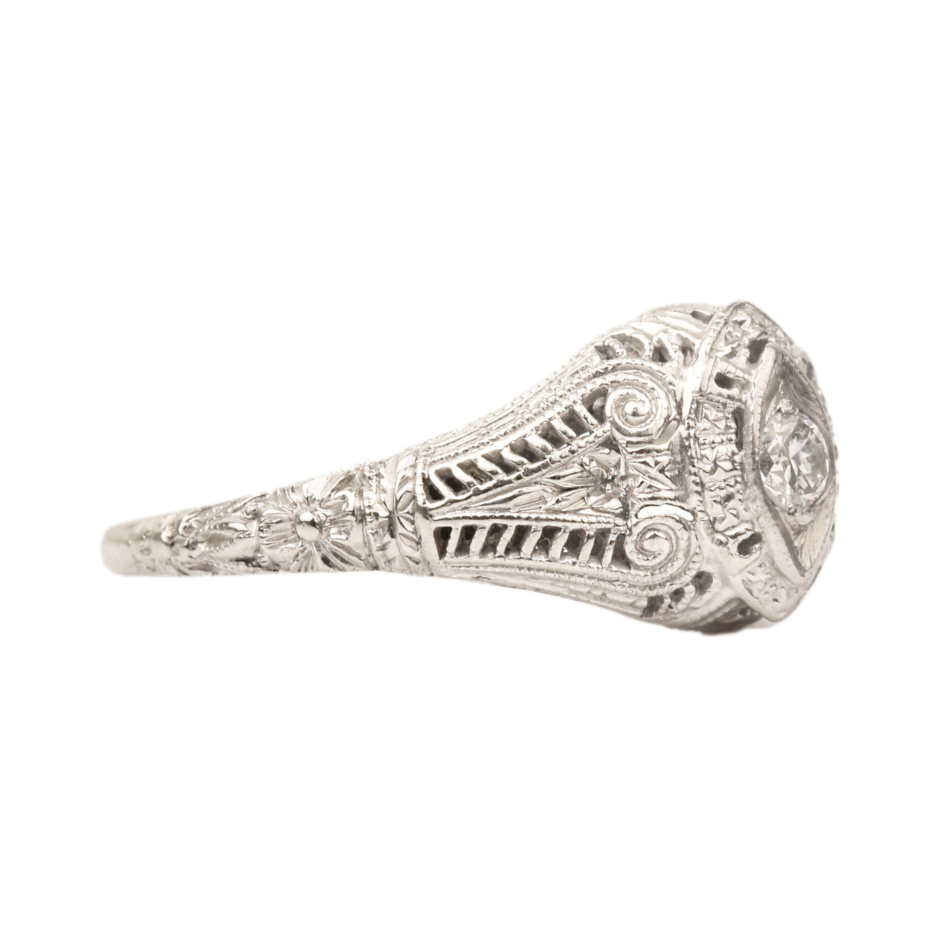 Art Deco 18K white gold filigree ring with 0.08 carat brilliant diamond, intricate detailing, size 6.25 US, isolated on white background.