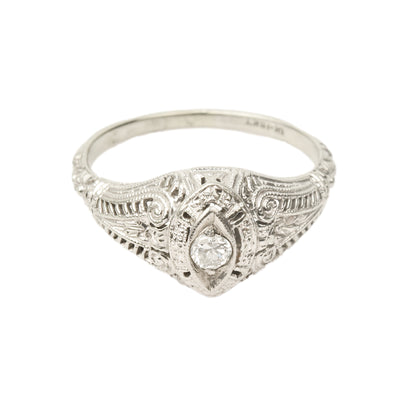 Art Deco 18K white gold filigree diamond solitaire ring with 0.08 carat brilliant diamond, intricate metalwork detail, size 6.25 US, isolated on white background.
