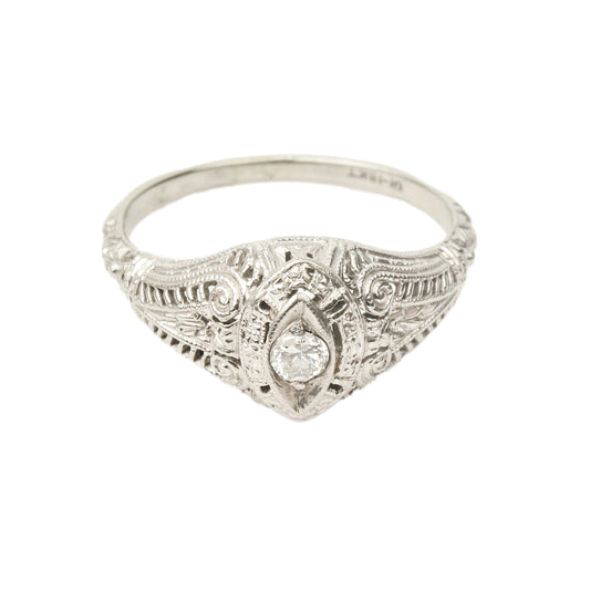 Art Deco 18K white gold filigree diamond solitaire ring with 0.08 carat brilliant diamond, intricate metalwork detail, size 6.25 US, isolated on white background.