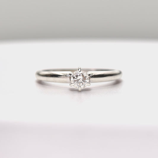 Minimalist 14K white gold diamond engagement ring with 0.25 carat brilliant solitaire on size 6.25 US band against a clean white background.