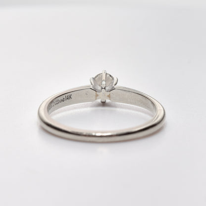 Minimalist 14K white gold diamond engagement ring with a quarter carat brilliant solitaire, size 6.25 US, displayed on a white background