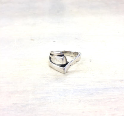 Vintage sterling silver geometric band ring on light background