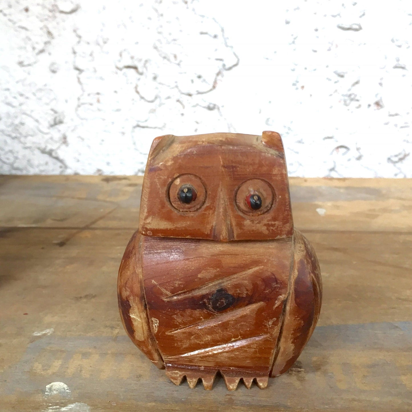 A wooden carved owl figure with large eyes, serving as a vintage pencil or pen holder, an example of folk art tramp art style carving, suitable as a back-to-school teacher's gift or desk organizer.