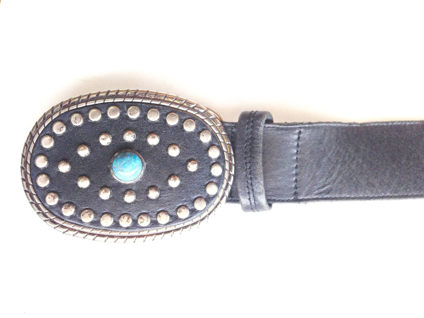 Vintage black leather belt with large oval silver buckle decorated with turquoise stones in a Southwestern style design.