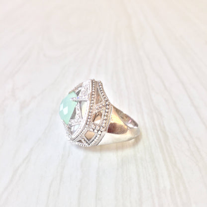 Vintage sterling silver statement ring with light green gemstone, intricate detailing and milgrain edging, perfect as an engagement ring or gift for her.