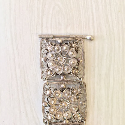 Vintage sterling silver filigree link bracelet with intricate floral design, crafted in 925 silver. Delicate flower motifs adorn each rectangular link. A stunning piece of silver jewelry and perfect holiday gift for her.