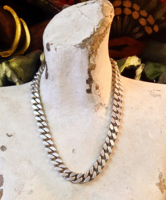 Vintage sterling silver thick chain necklace from Italy, suitable for men or women. The chunky chain links have an aged, rustic appearance against the white stone background, with pine cones and foliage adding an autumn theme to the jewelry photography.