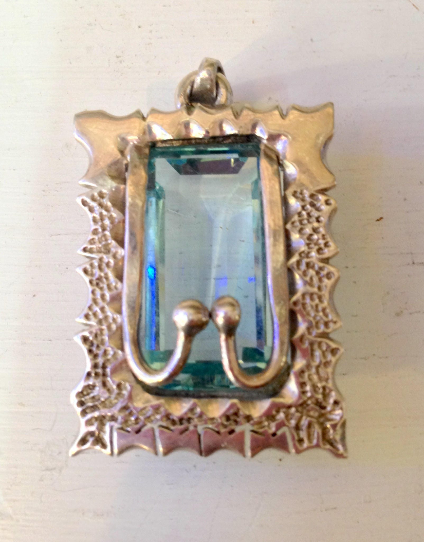 Vintage sterling silver pendant with aquamarine stone and ornate framed design