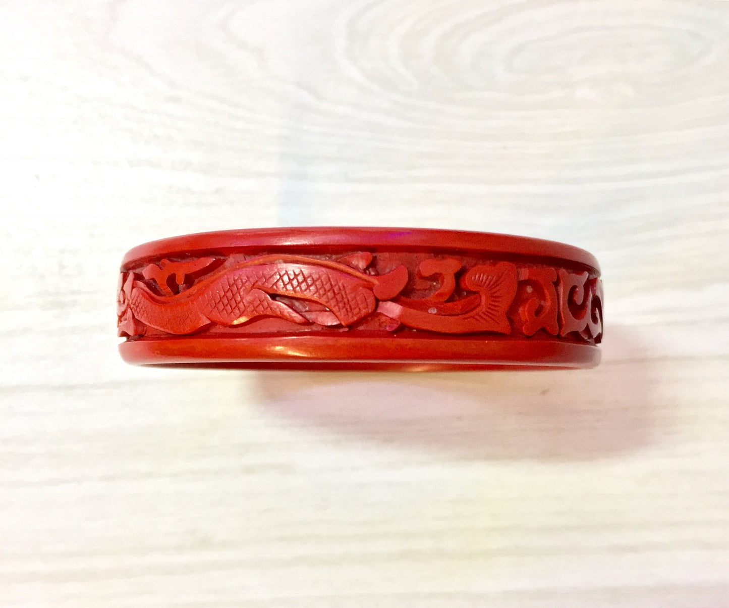 Vintage carved red cinnabar bangle bracelet featuring Asian dragon motif design