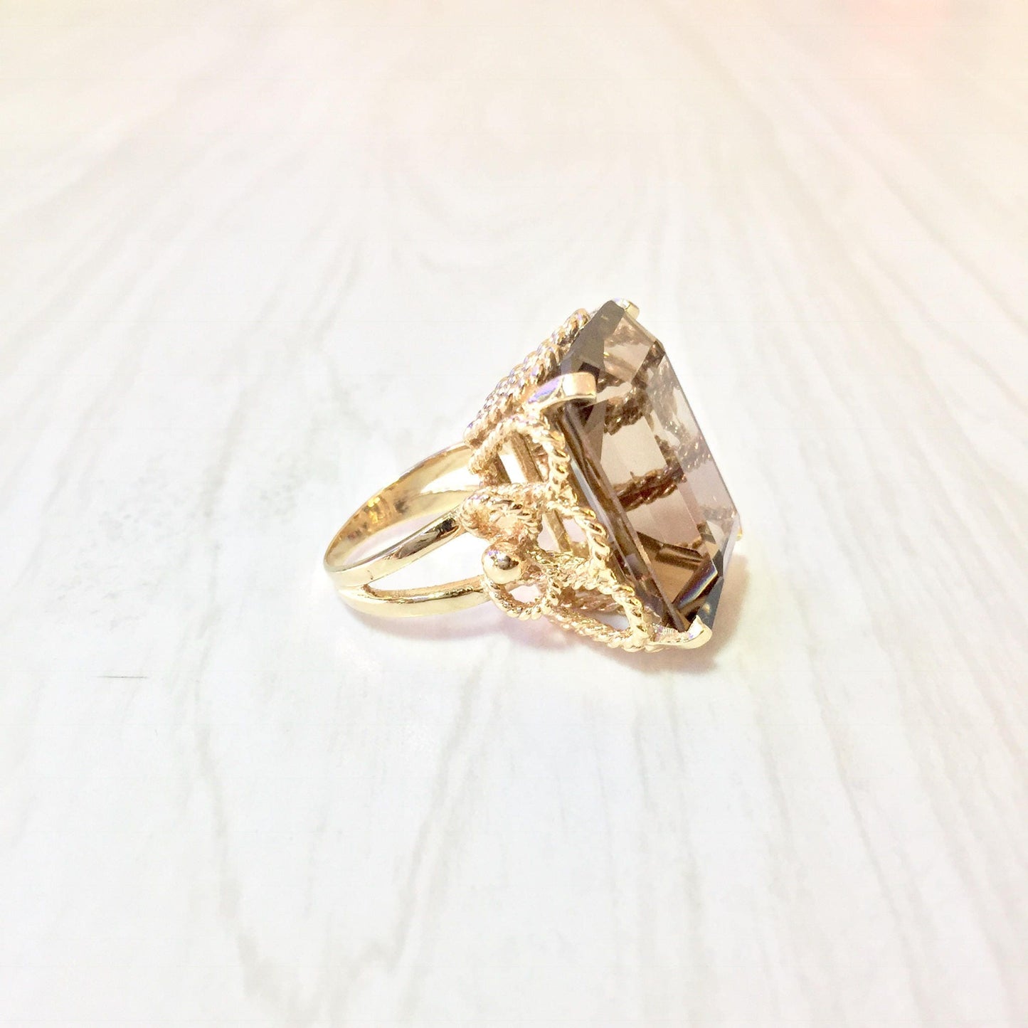 14K yellow gold ring featuring an emerald cut smoky quartz gemstone in an ornate vintage-inspired setting, perfect as a statement cocktail ring or eye-catching jewelry gift.