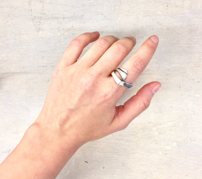 Sterling silver vintage ring on hand against light background