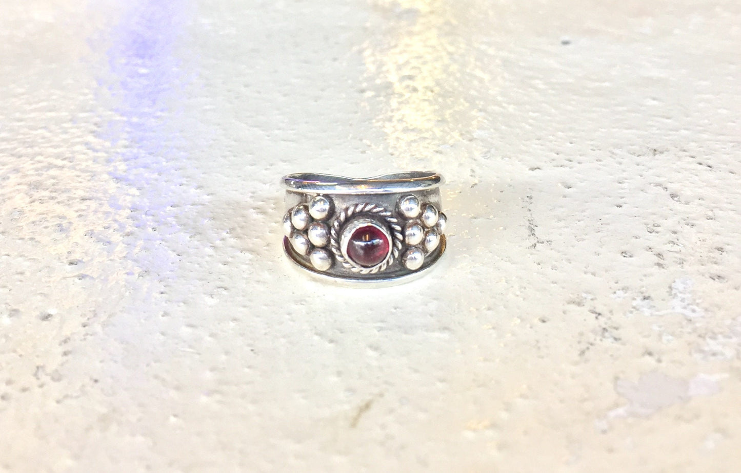 Vintage sterling silver ring with red garnet gemstone in Celtic gothic design.