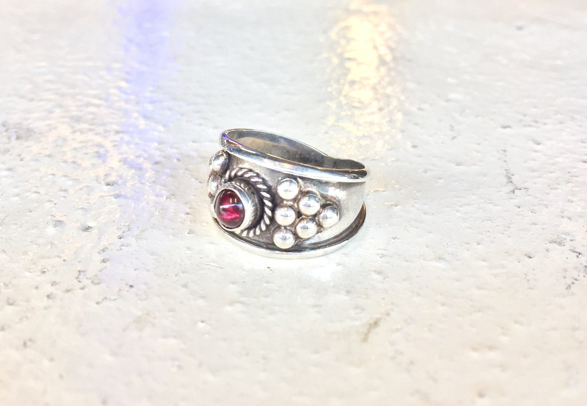 Vintage sterling silver ring with red garnet gemstone and ornate Celtic design