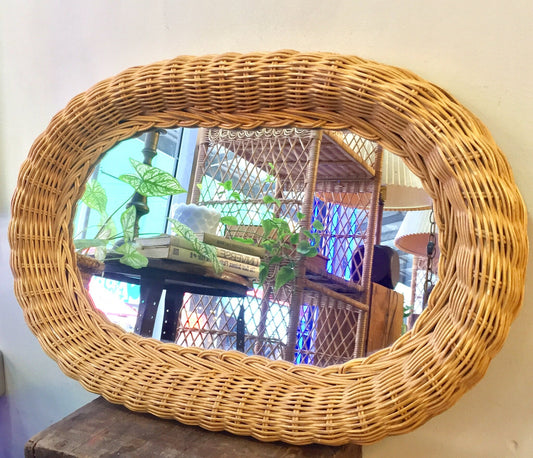 Vintage oval wicker rattan mirror with decorative weave, perfect for bohemian or beach house home decor.