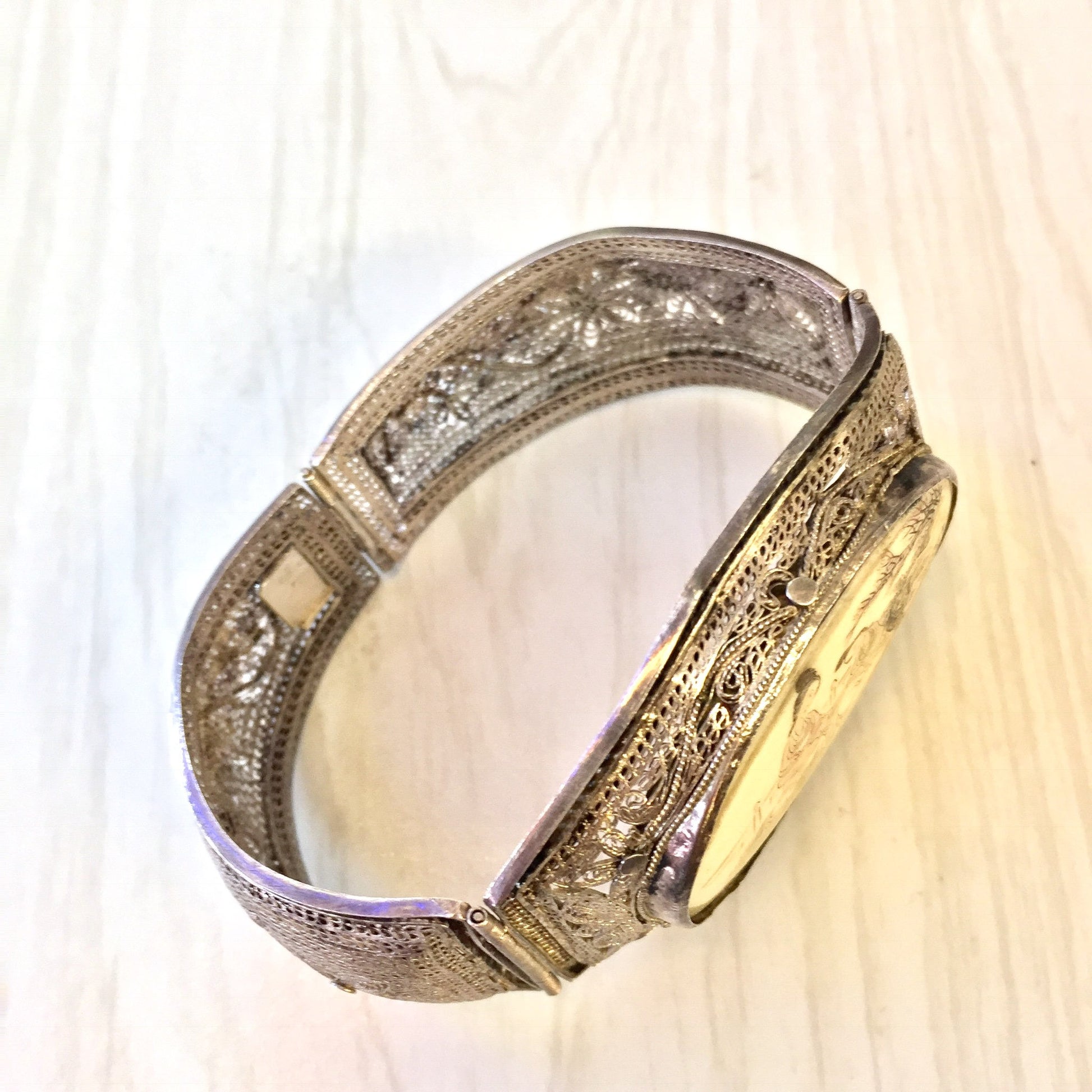 Antique sterling silver filigree hinged bracelet with intricately carved Asian horn design, a unique piece of vintage Asian jewelry featuring delicate silver metalwork and scrimshaw-style carvings on the horn inlay.