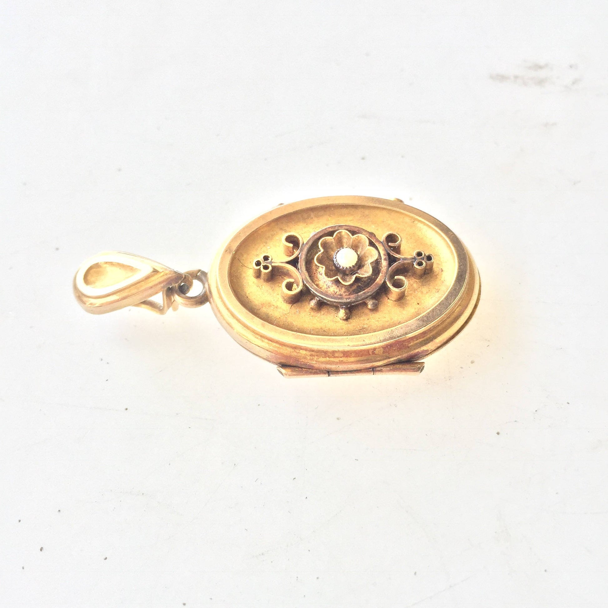 Antique 10 karat gold oval Victorian locket charm pendant necklace with floral design and green enamel accents, a keepsake jewelry gift for her.