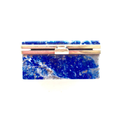 Vintage rectangular blue lapis stone box with gold lining, used as a small antique keepsake or trinket box. The vibrant blue stone has crystalline flecks and veins throughout.