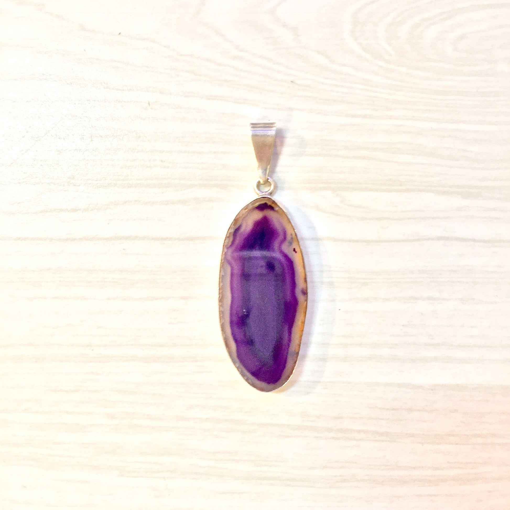 Purple agate pendant crafted in sterling silver, featuring a large oval-shaped gemstone with vibrant purple hues. The pendant hangs from a silver bail, creating a striking vintage-inspired necklace that makes a perfect gift for her.