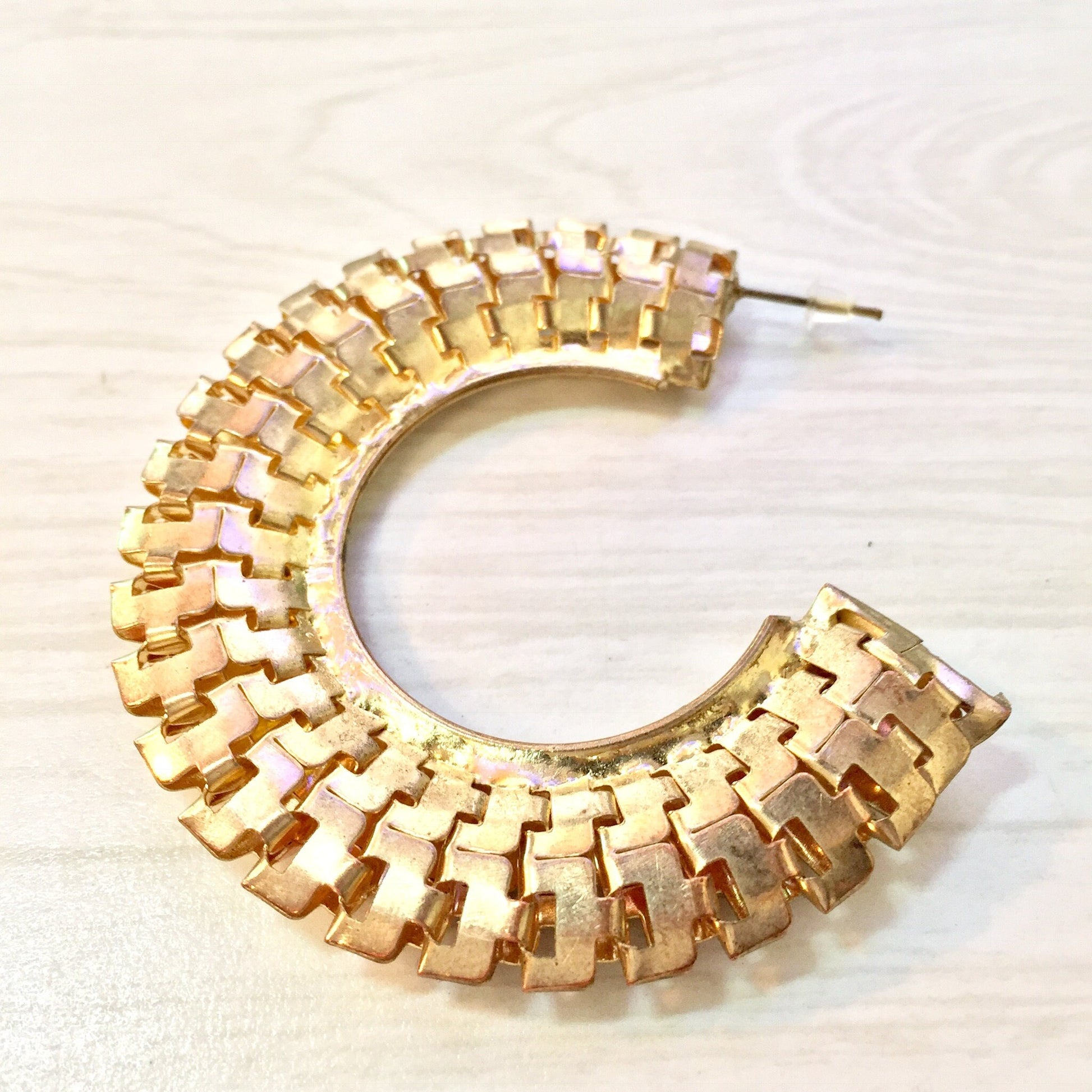 Gold-toned vintage costume jewelry hoop earrings in a woven or braided texture, reminiscent of 80s or 90s fashion statement jewelry. Potential holiday gift idea.