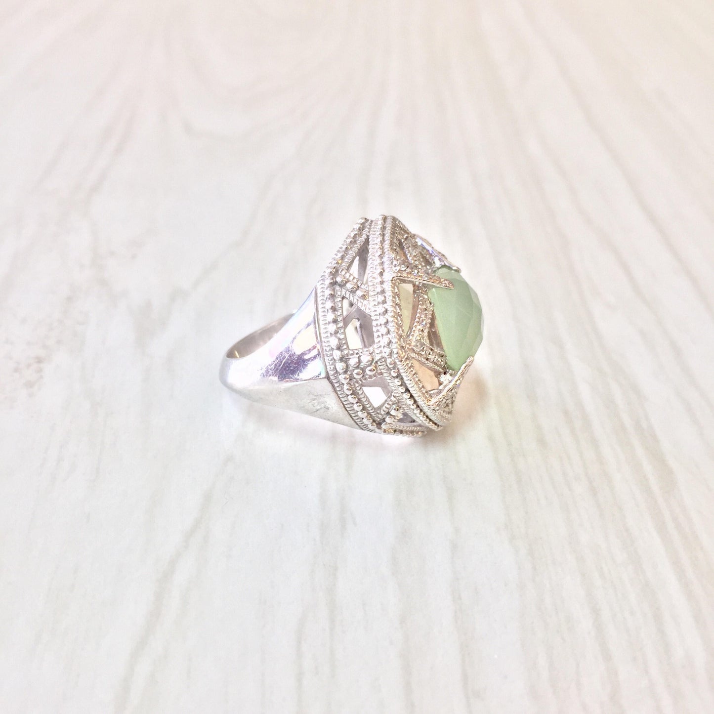 Elegant vintage sterling silver ring with light green center stone and intricate detailing, perfect as a unique engagement or statement ring gift for her.