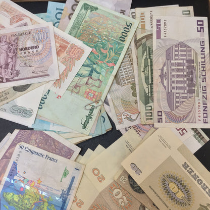 Vintage foreign currency banknotes from various countries, including Hong Kong, Ethiopia, France, and more, arranged in a scattered pattern. The colorful bills feature intricate designs and denominations, suitable for scrapbooking, crafts, or collecting old paper money.