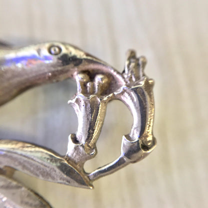 Vintage sterling silver bird brooch designed by Guglielmo Cini for Gump's, featuring detailed metalwork depicting a perched bird in profile view.