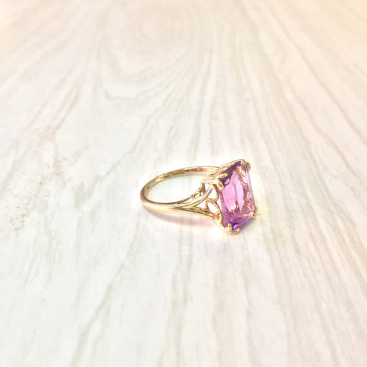 14K gold ring featuring an emerald cut amethyst gemstone, a stunning statement or engagement ring showcasing precious stones.