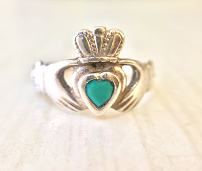 Vintage sterling silver Claddagh ring with blue-green heart shaped stone, intricate Celtic knot design on the crown and hands clasping the heart.