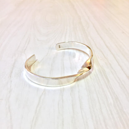 Sterling silver cuff bracelet with minimalist twist design, a classic and timeless piece of 925 jewelry.