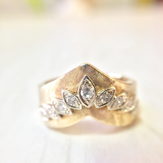 14 karat yellow gold diamond chevron V-shaped stackable engagement ring closeup on light background