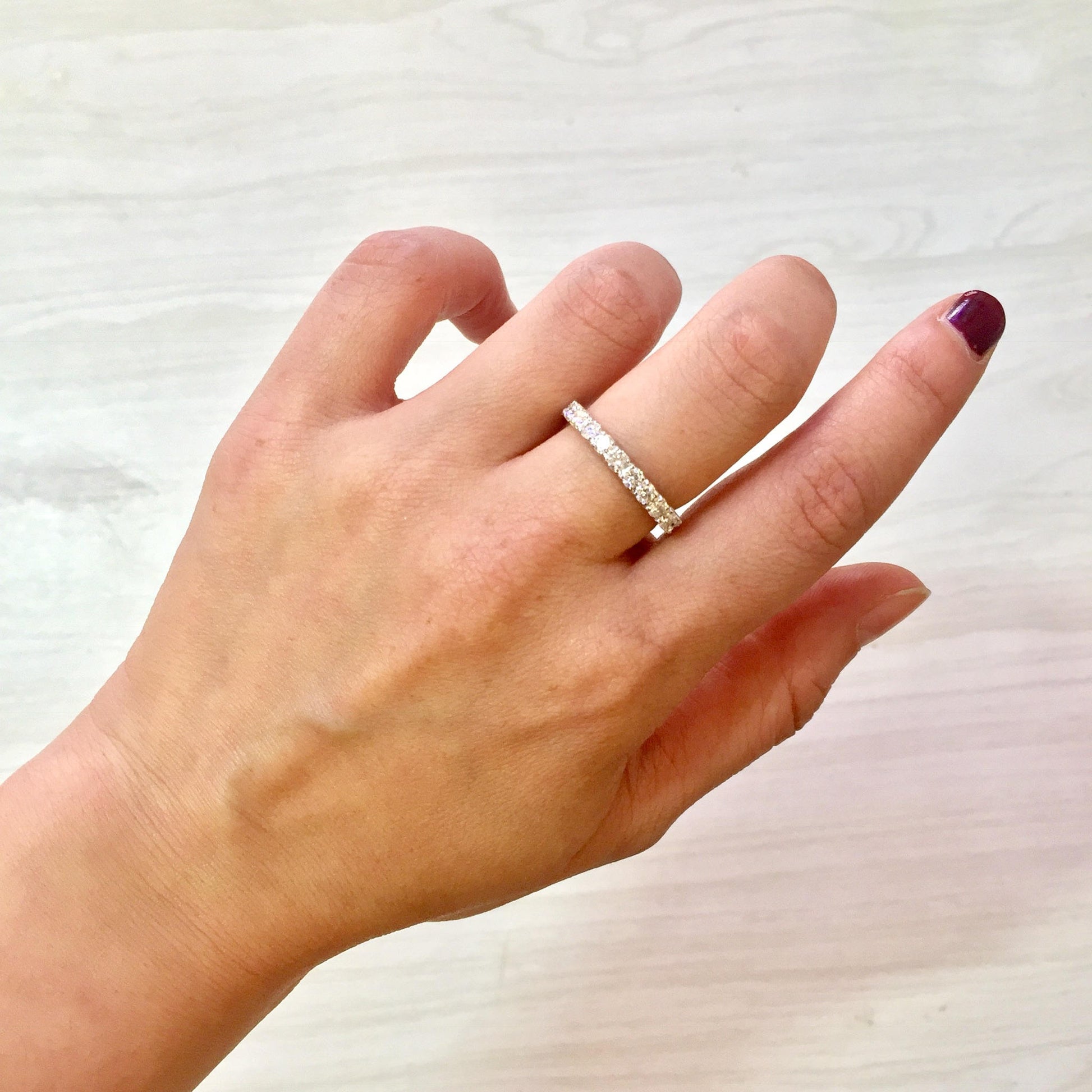 14 karat white gold diamond eternity wedding band ring on model's hand