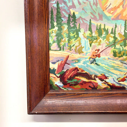 Vintage framed paint by numbers oil painting depicting a serene mountain lake fishing scene in vibrant colors, set in a rustic wooden frame.