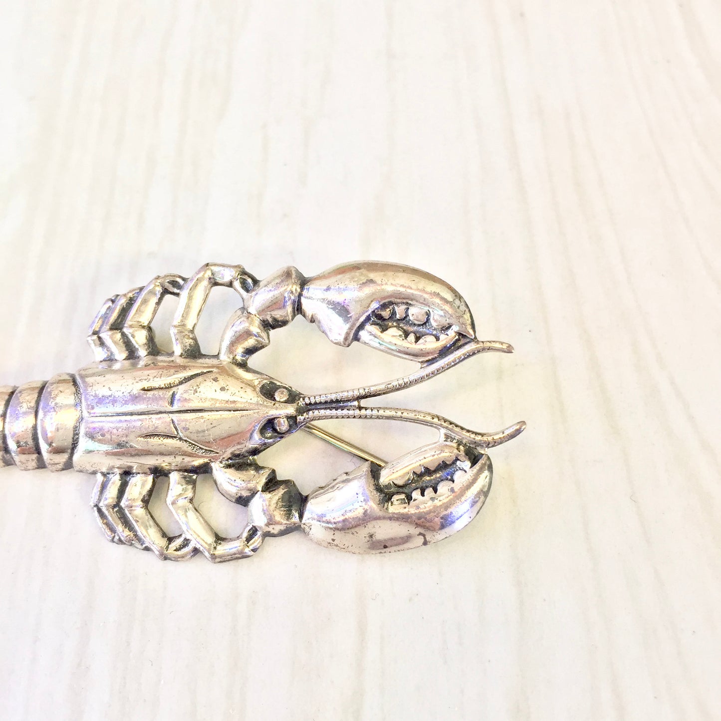 Vintage sterling silver lobster brooch pin, intricately detailed crustacean design, perfect holiday gift idea or addition to any vintage jewelry collection.