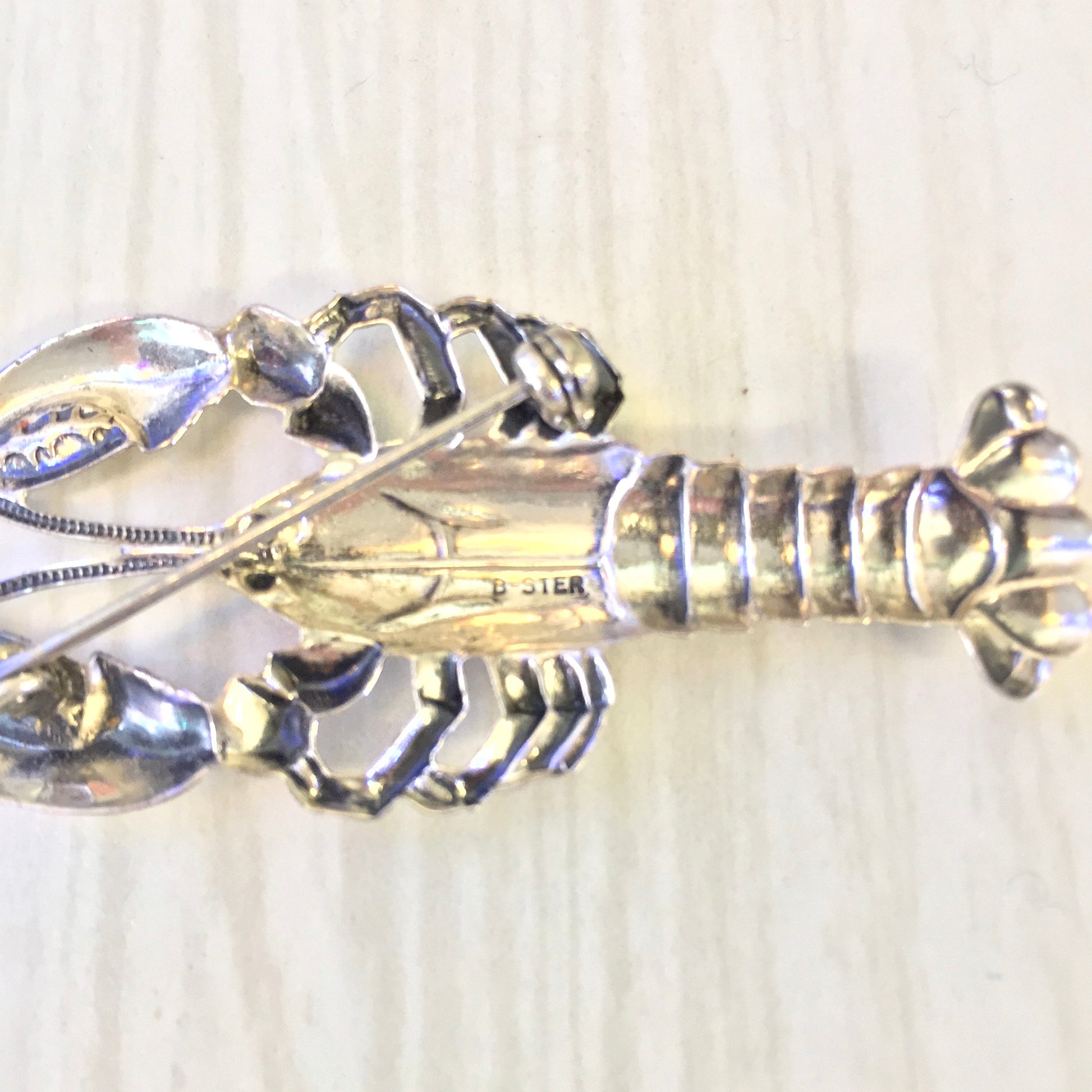 Vintage sterling silver lobster brooch pin featuring intricate details and a polished finish, perfect as a unique holiday jewelry gift idea.