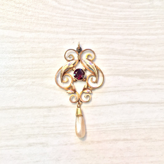 10 karat gold antique pendant with swirling design, featuring a dangling freshwater pearl and a round purple amethyst gemstone in the center.