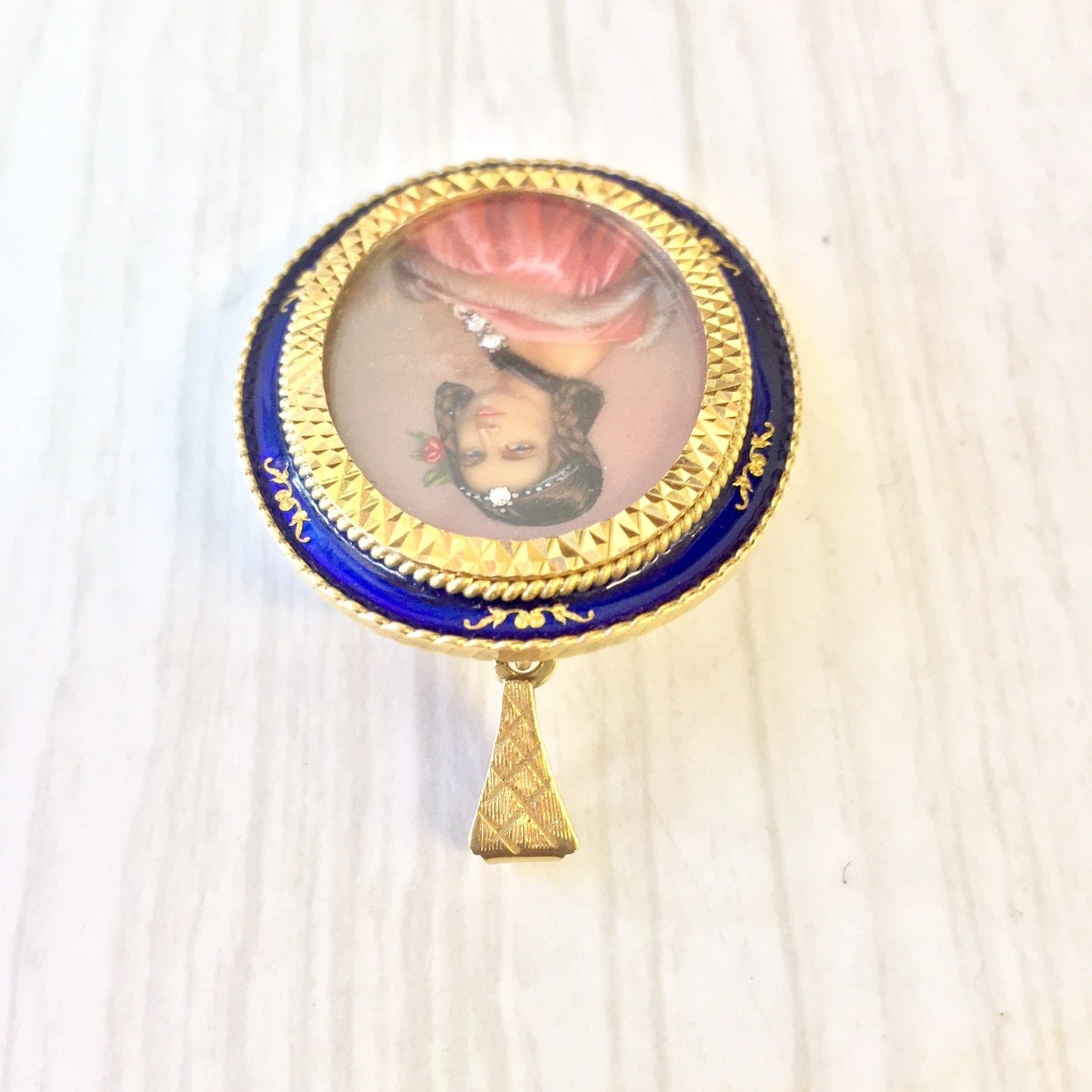 18 karat gold Victorian cameo brooch pendant featuring a woman's portrait, trimmed with blue enamel and accented with a diamond, can be worn as an antique pin or pendant