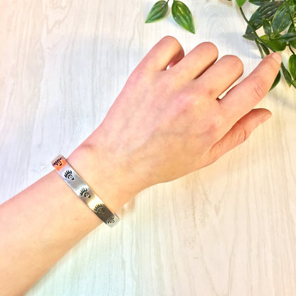 Vintage silver bear paw cuff bracelet on woman's wrist, Native American jewelry for Valentine's Day gift