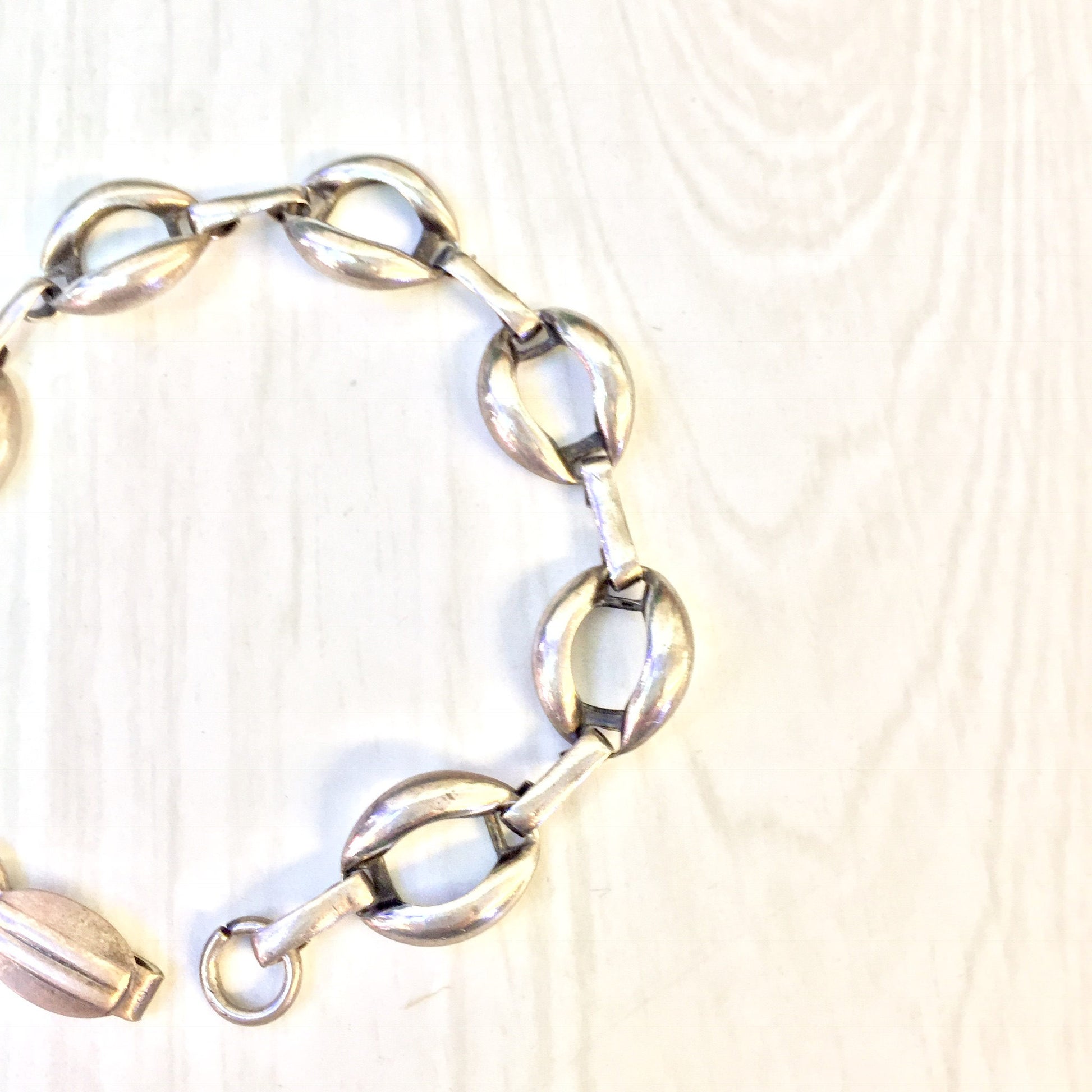 Vintage sterling silver link bracelet on wooden surface, perfect simple jewelry gift for Valentine's Day or any occasion.