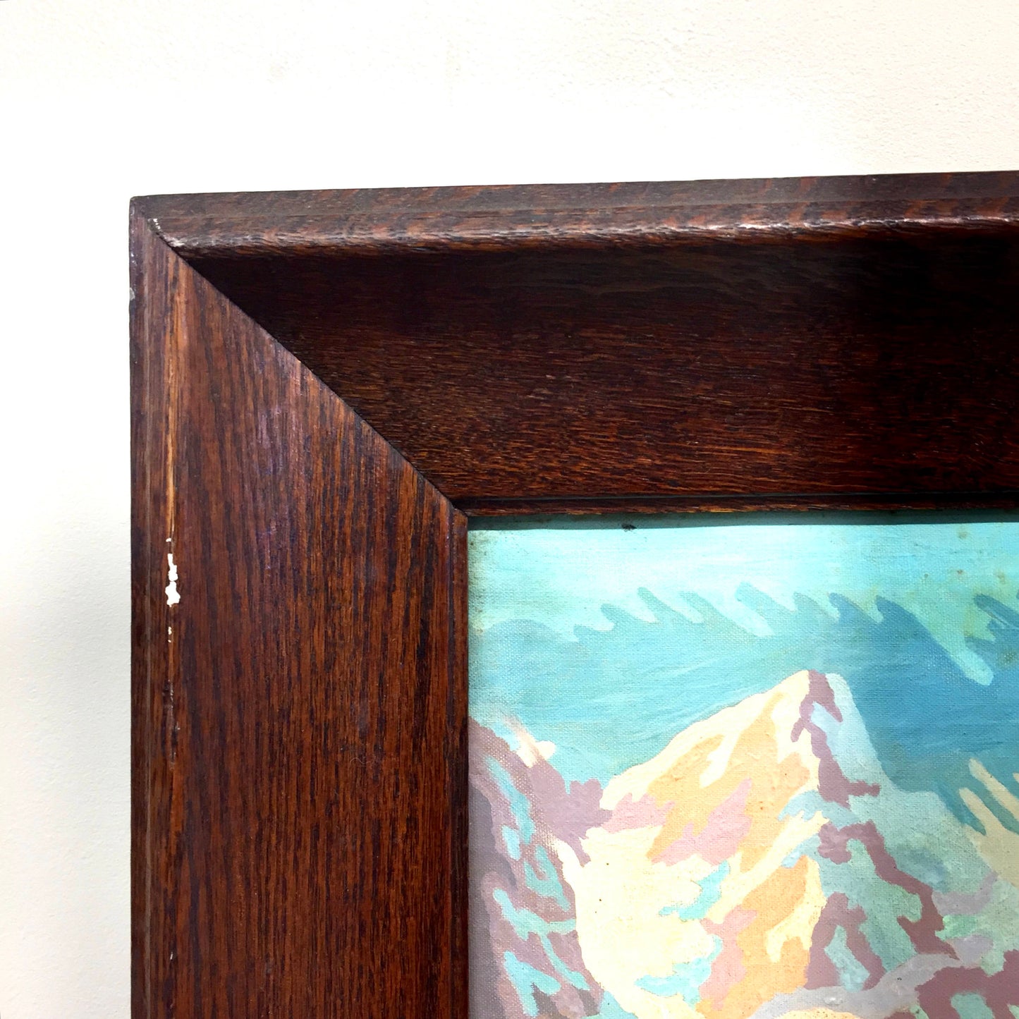 Vintage framed paint by numbers oil painting depicting a mountain landscape, with a wooden frame and close-up detail of the colorful brushwork.