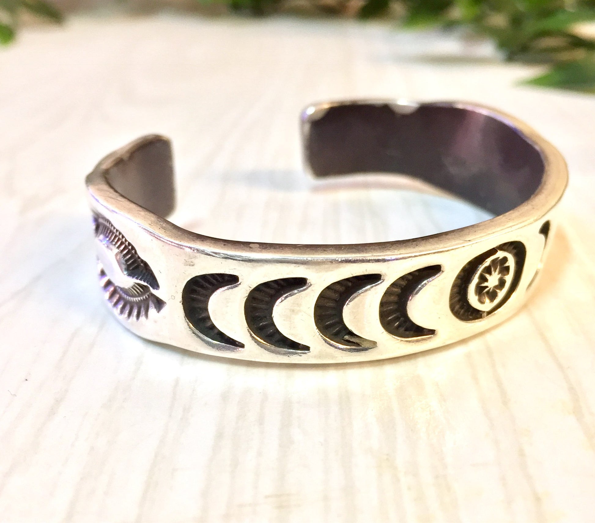 Vintage Hopi silver cuff bracelet with stamped sun, moon, and star designs, a rare Native American jewelry gift idea.