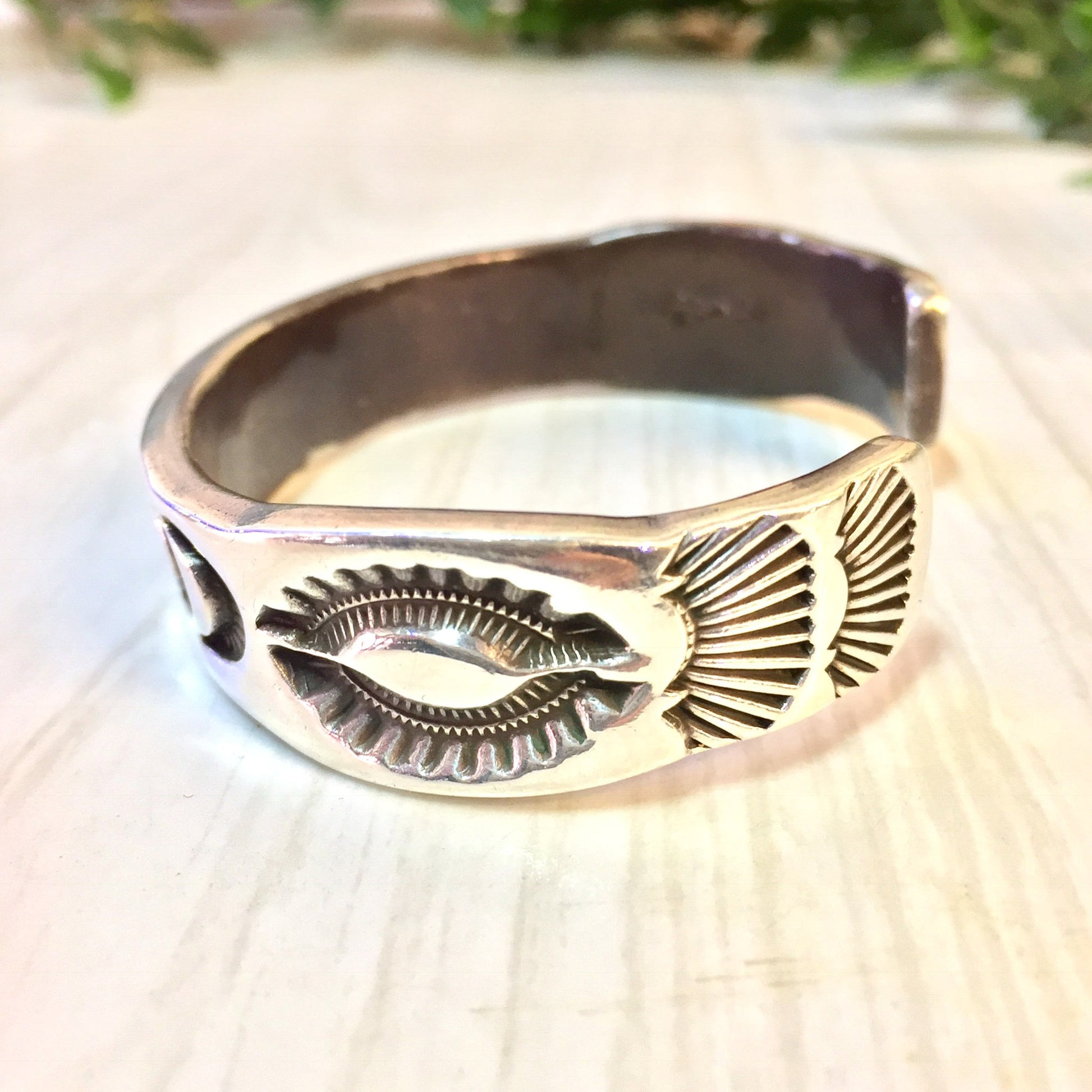 Vintage Hopi silver cuff bracelet featuring stamped sun, moon and star designs, a rare piece of Hopi jewelry suitable as a gift.